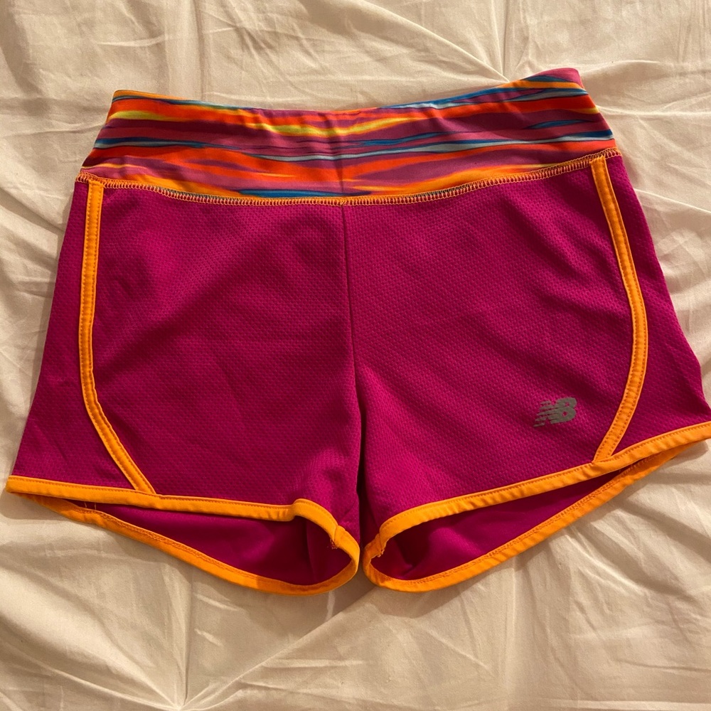 New Balance pink and orange workout shorts.